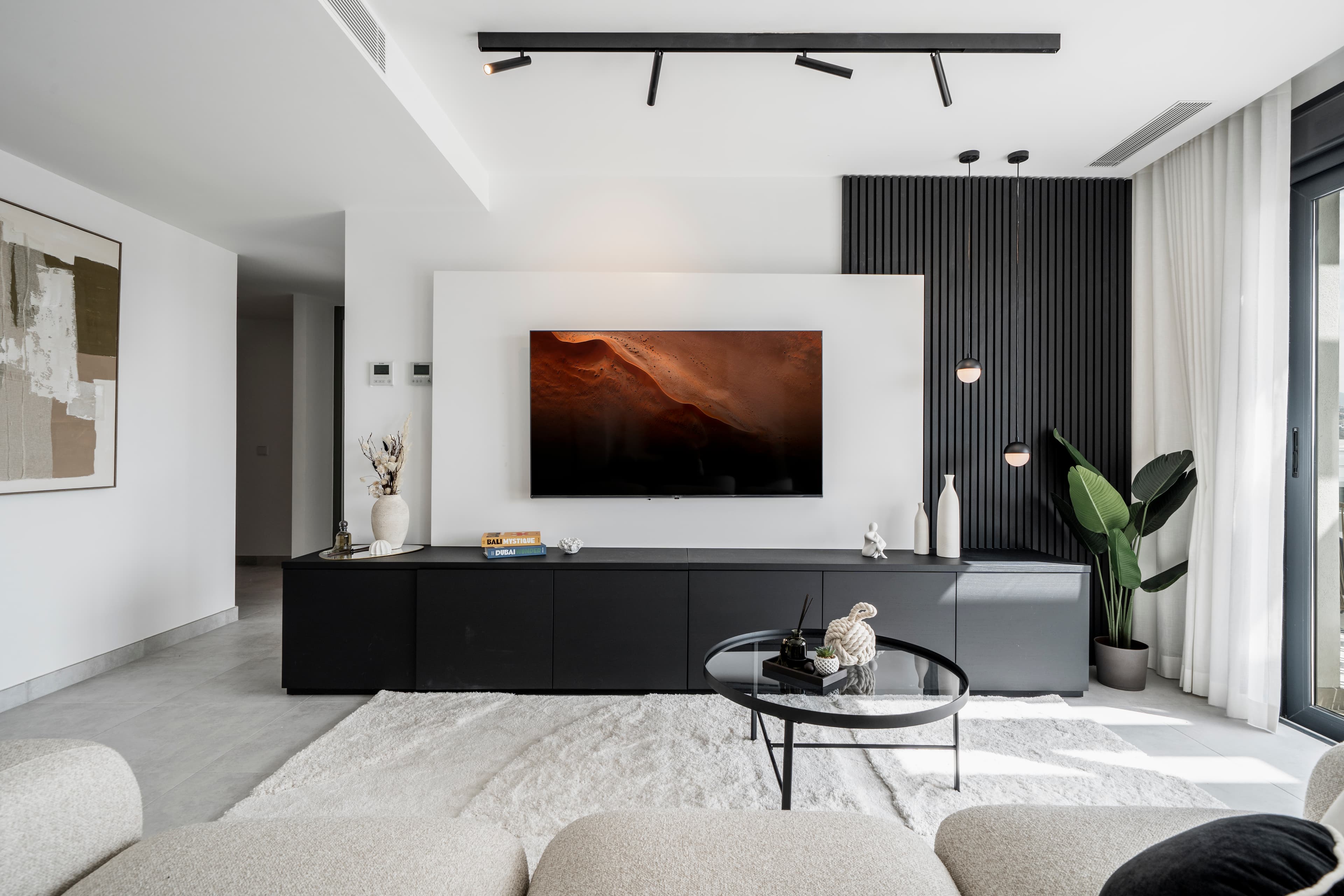 Milay Studio philosophy — modern living room with black slat panel and contemporary design